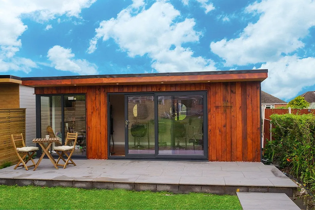Cedar-clad garden room with wide glazing and a seating area
