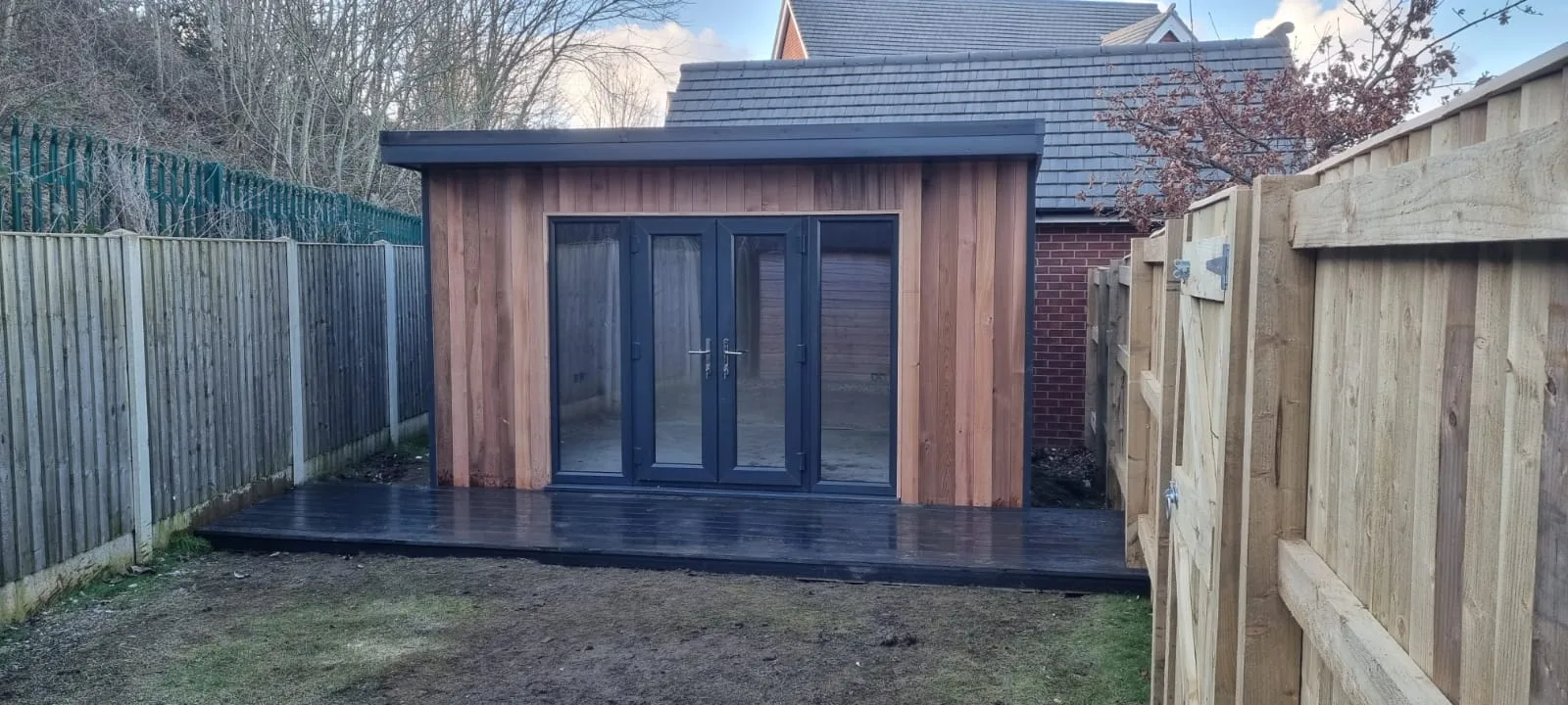 Compact timber garden office at the end of a garden